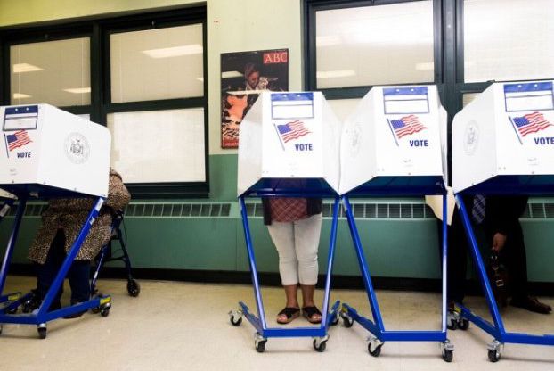 Voters in NYC cast their ballots behind blinders.